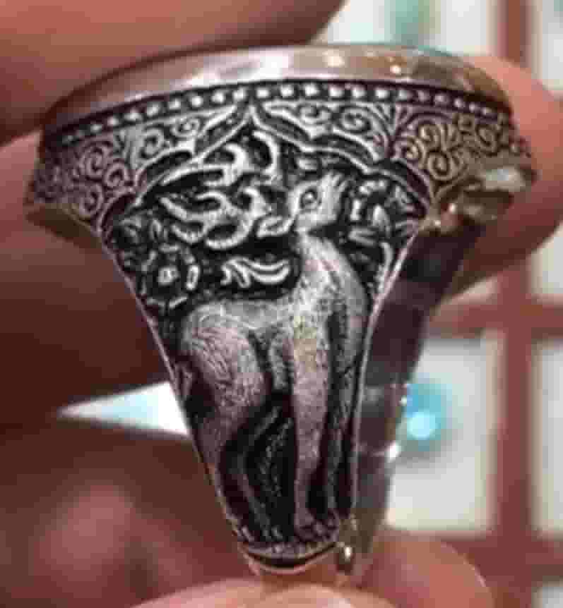 A silver ring engraved with Hamid Genki and the stone Fairuz Nishaburi